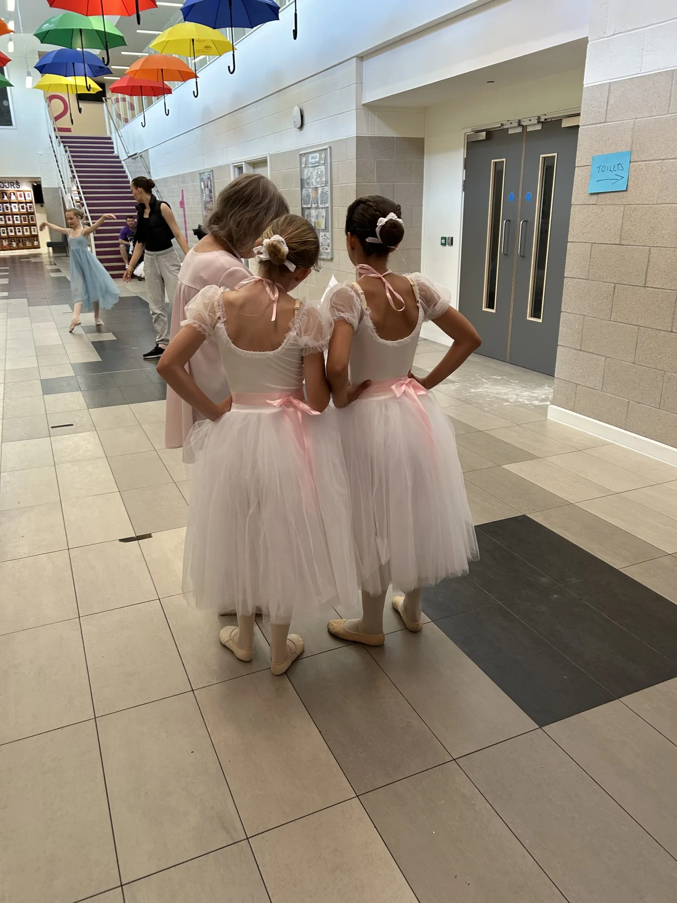 Young dancers backstage in ballet costumes