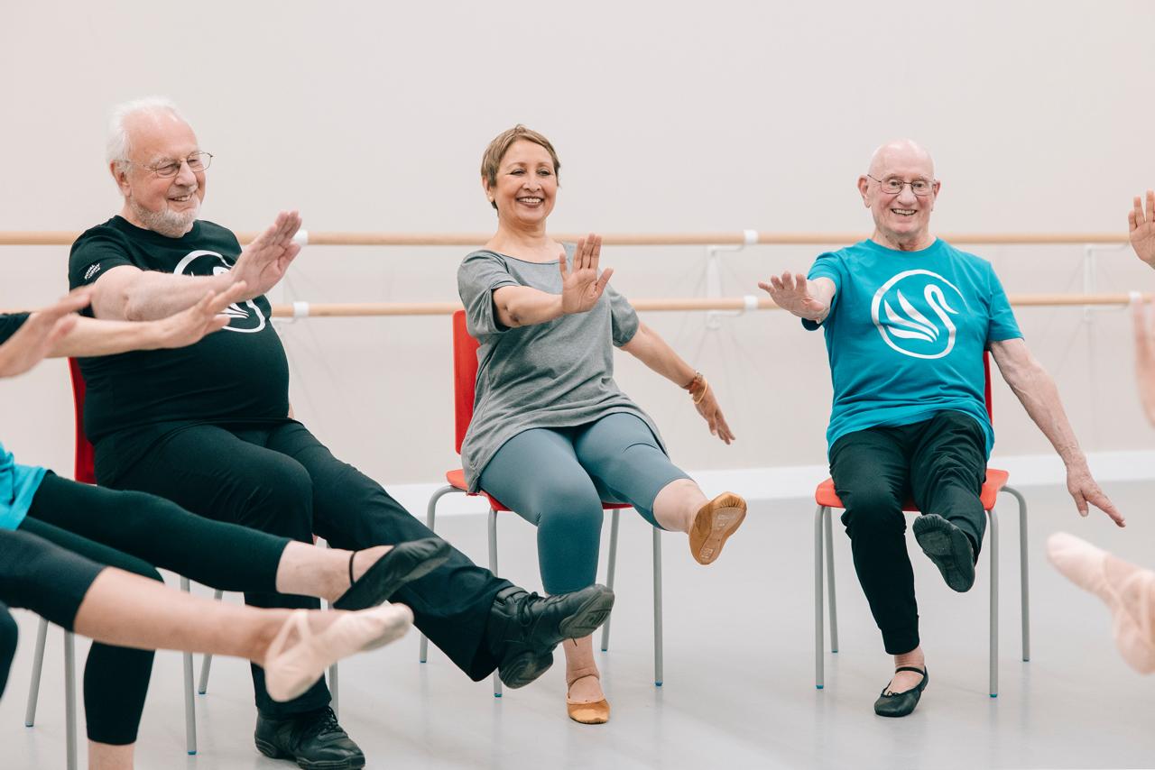 Adults enjoying accessible, seated ballet-inspired movement together